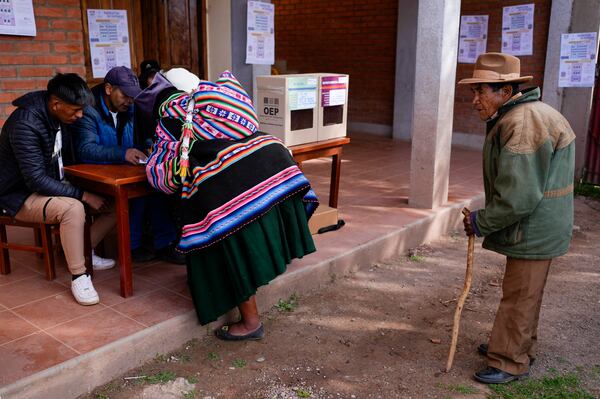 An Aymara woman registers to cast her ballot at a polling station during judicial elections in Jesus de Machaca, Bolivia, Sunday, Dec. 15, 2024. (AP Photo/Juan Karita)