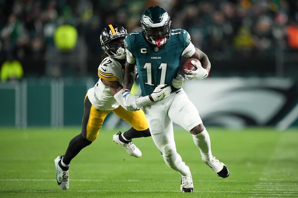 Philadelphia Eagles wide receiver A.J. Brown (11) runs with the ball as Pittsburgh Steelers cornerback James Pierre (42) tries to stop him during the second half of an NFL football game Sunday, Dec. 15, 2024, in Philadelphia. (AP Photo/Matt Slocum)