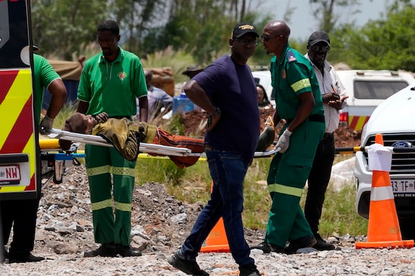 A miner is transported on a stretcher by rescue workers after he was rescued from below ground in an abandoned gold mine in Stilfontein, South Africa, Tuesday, Jan. 14, 2025. (AP Photo/Themba Hadebe)