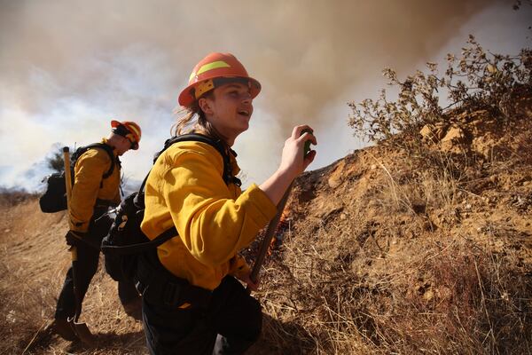 Firefighters work to control the spread of the Hughes Fire in Castaic, Calf., Wednesday, Jan. 22, 2025. (AP Photo/Ethan Swope)