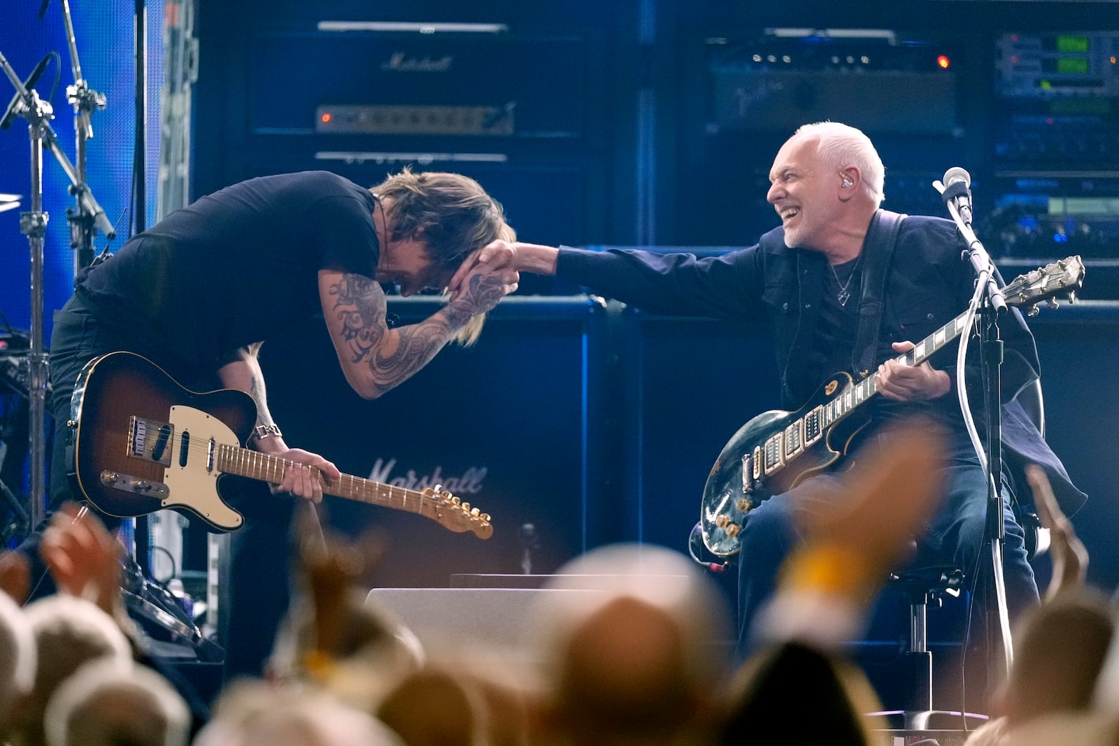 Keith Urban, left, and Peter Frampton perform during the 39th Annual Rock & Roll Hall of Fame Induction Ceremony on Saturday, Oct. 19, 2024, at Rocket Mortgage FieldHouse in Cleveland. (AP Photo/Chris Pizzello)