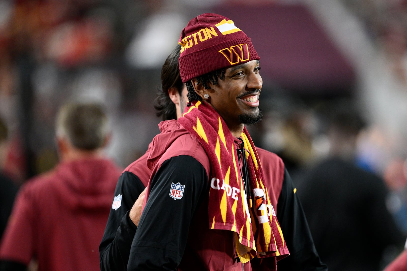 Washington Commanders quarterback Jayden Daniels stands on the sideline during the second half of an NFL football game against the Carolina Panthers, Sunday, Oct. 20, 2024, in Landover, Md. (AP Photo/Nick Wass)