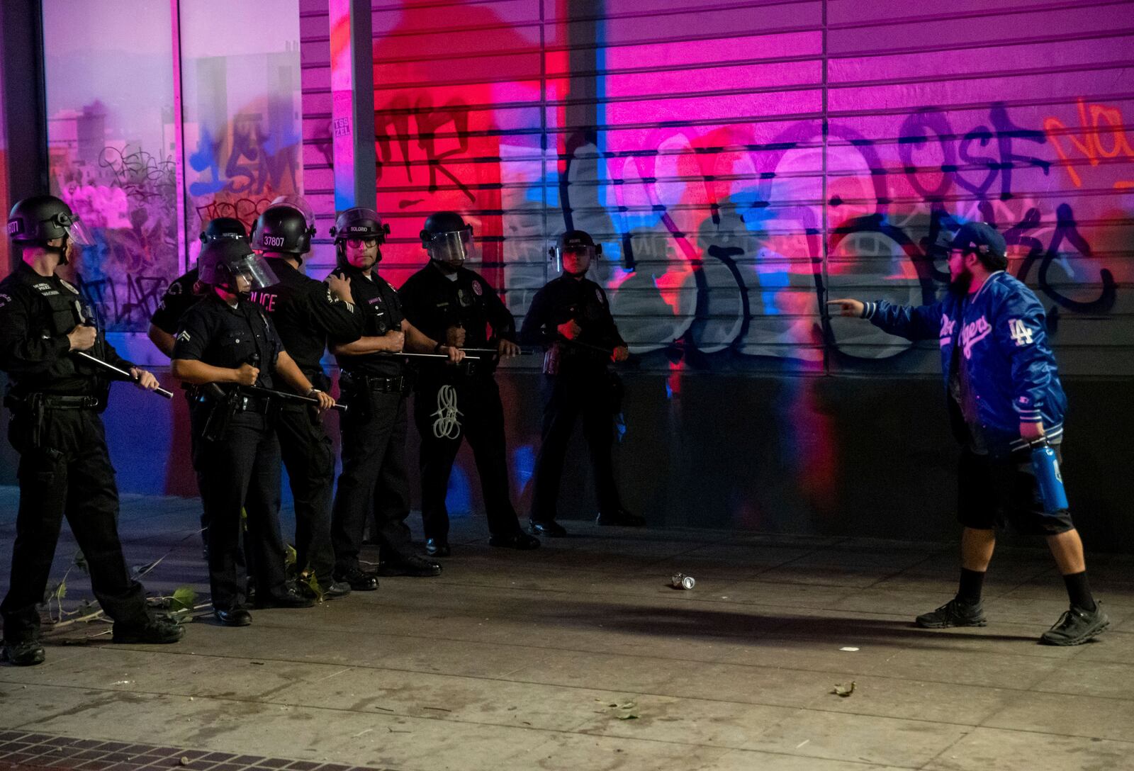 A fan confronts police on the streets after the Los Angeles Dodgers won against the New York Yankees in the baseball World Series Wednesday, Oct. 30, 2024, in Los Angeles. (AP Photo/Ethan Swope)