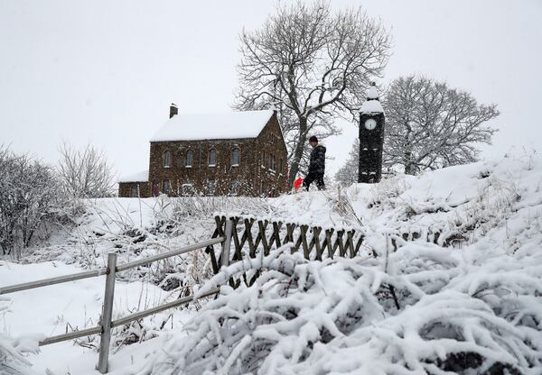 Lowson Robinson is pictured in the heavy snow with his scaled miniature famous landmarks which are located in his garden in Nenthead, England, as the severe weather continues across England, Sunday, Jan. 5, 2025. (AP Photo/Scott Heppell)