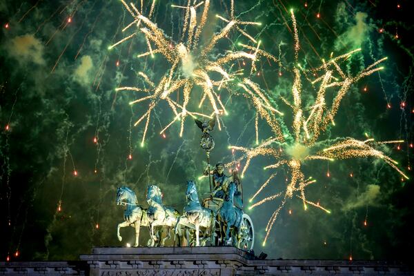 Fireworks light the sky above the Quadriga at the Brandenburg Gate during New Year's celebrations shortly after midnight in Berlin, Germany, Wednesday, Jan. 1, 2025. (AP Photo/Ebrahim Noroozi)