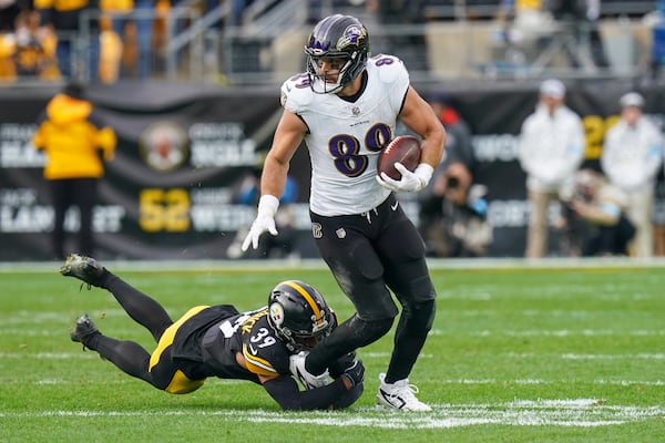 Baltimore Ravens tight end Mark Andrews (89) runs with the ball as Pittsburgh Steelers safety Minkah Fitzpatrick tries to stop him during the second half of an NFL football game, Sunday, Nov. 17, 2024, in Pittsburgh. (AP Photo/Matt Freed)