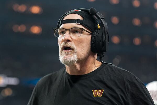 Washington Commanders head coach Dan Quinn watches against the Detroit Lions during the first half of an NFL football divisional playoff game, Saturday, Jan. 18, 2025, in Detroit. (AP Photo/Seth Wenig)