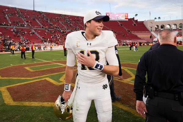 Notre Dame quarterback Riley Leonard reacts after the team's win against Southern California in an NCAA football game Saturday, Nov. 30, 2024, in Los Angeles. (AP Photo/Ryan Sun)