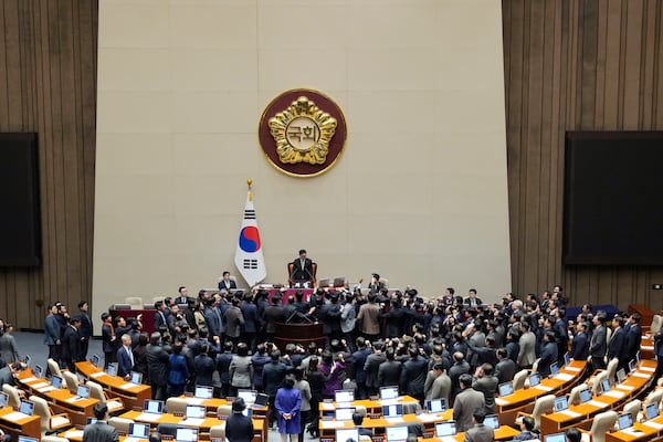 Lawmakers of the ruling People Power Party protest to South Korea's National Assembly Speaker Woo Won Shik, top center, during a plenary session for the impeachment motion against South Korean acting President Han Duck-soo at the National Assembly in Seoul, South Korea, Friday Dec. 27, 2024. (AP Photo/Ahn Young-joon)