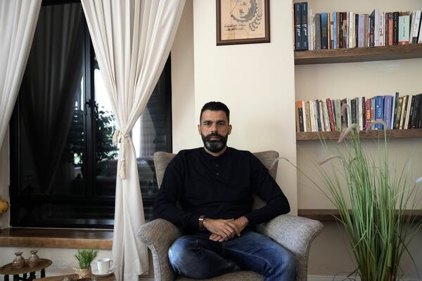 Ahmed Khalefa, a Palestinian citizen of Israel who is charged with incitement to terrorism for demonstrating against the war in Gaza, poses for a portrait at home in Umm al-Fahm, Israel, Wednesday, Nov. 20, 2024. (AP Photo/Mahmoud Illean)