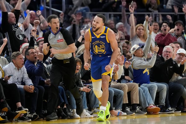 Golden State Warriors guard Stephen Curry (30) reacts after making a 3-point basket during the second half of an NBA basketball game against the Indiana Pacers in San Francisco, Monday, Dec. 23, 2024. (AP Photo/Jeff Chiu)