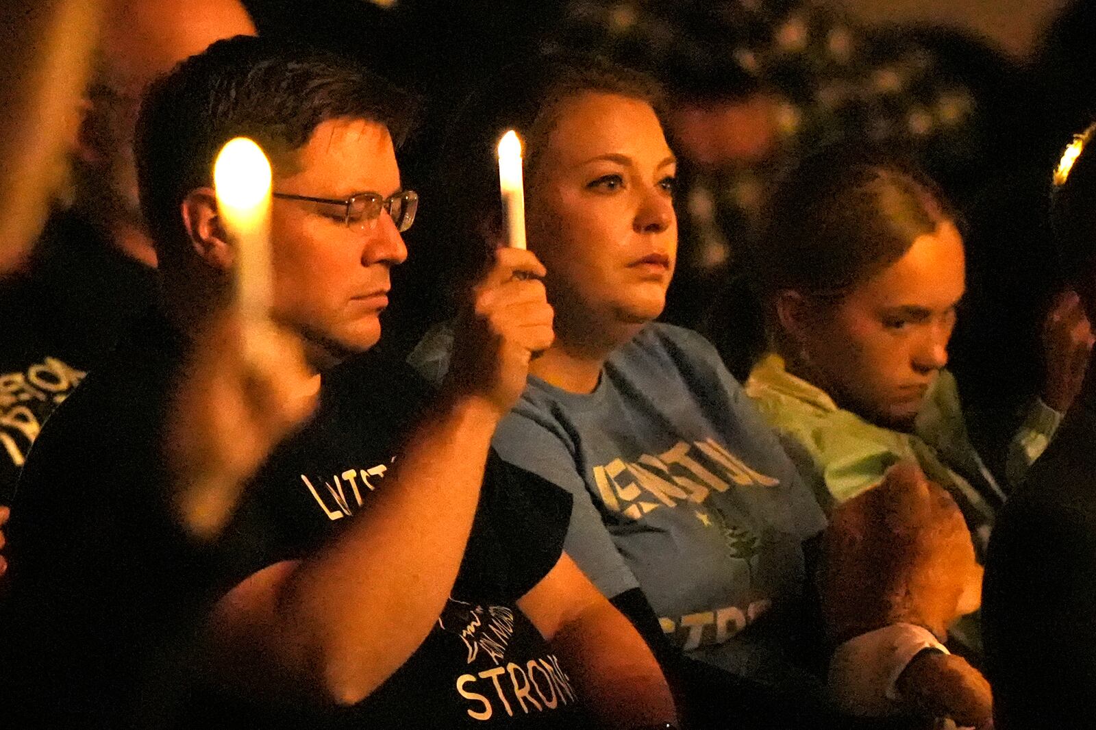 Attendees observe a moment of silence at a commemoration event to mark the one year anniversary of the mass shooting in Lewiston, Maine, Friday, Oct. 25, 2024. (AP Photo/Robert F. Bukaty)