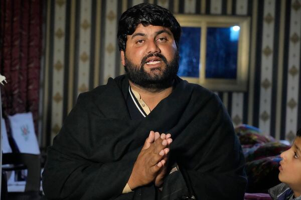 Ahsan Shahzad father of Suffian Ali, one of the victims of a migrant boat that capsized in West Africa's Atlantic coastline, speaks to reporters at his home in the village of Dhola, Lalamusa district, Pakistan, Friday, Jan. 17, 2024. (AP Photo/K.M. Chaudary)