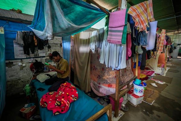 A Meitei man combs his hair in a relief camp in Imphal, Manipur, Monday, Dec. 16, 2024. (AP Photo/Anupam Nath)