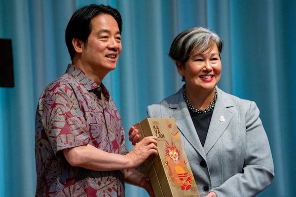 Taiwanese President Lai Ching-te, left, presents a gift to East-West Center President Suzanne Vares-Lum at the East-West Center, Sunday, Dec. 1, 2024, in Honolulu, Hawaii. (AP Photo/Mengshin Lin)