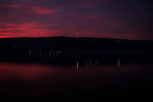 Lights are reflected in the water at dusk from the left bank of the Dniester river, the border between Moldova and Transnistria, seen from Molovata, Moldova, Wednesday, Jan. 8, 2025. (AP Photo)