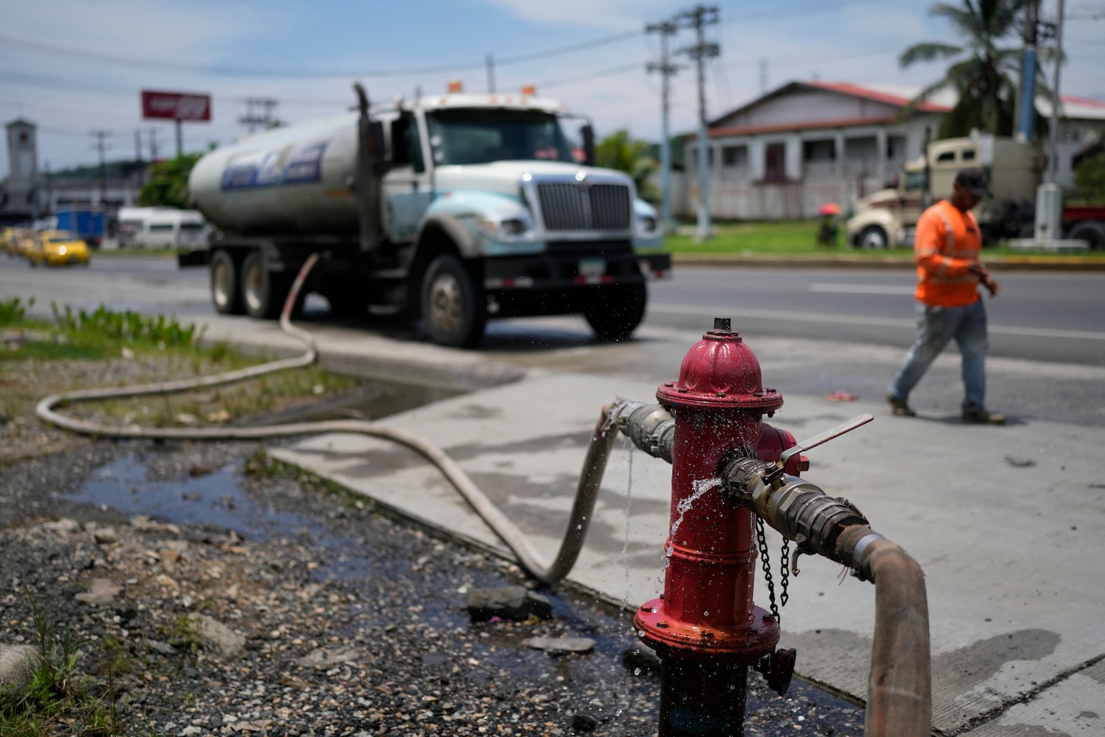 A water truck fills up at a fire hydrant to distribute to buildings in Colon, Panama, Monday, Sept. 2, 2024. In a proposed plan to dam the nearby Indio River and secure the Panama Canal's uninterrupted operation, the community would gain more reliable access to water. (AP Photo/Matias Delacroix)