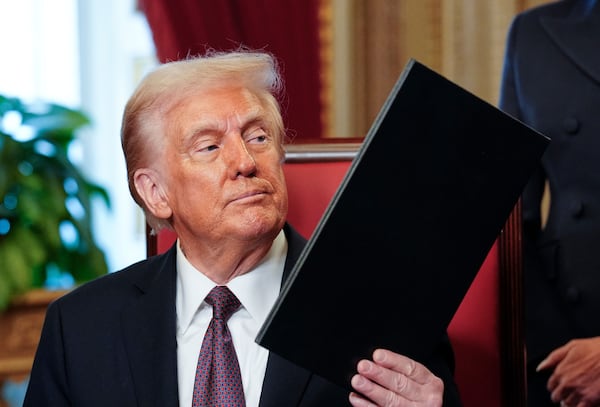 President Donald Trump, center, takes part in a signing ceremony in the President's Room after the 60th Presidential Inauguration, Monday, Jan. 20, 2025, at the U.S. Capitol in Washington. (Melina Mara/The Washington Post via AP, Pool)