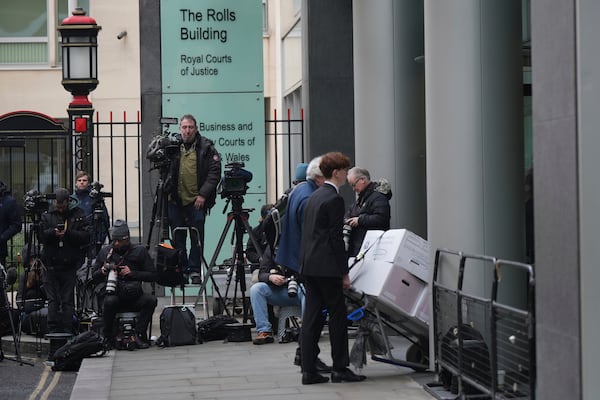 The media watch as lawyers and their staff arrive at the High Court as Prince Harry's legal action against News Group Newspapers over allegations of unlawful information gathering begins in London, Tuesday, Jan. 21, 2025. (AP Photo/Alastair Grant)