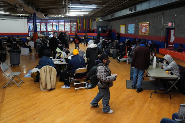 Patrons sit inside a daytime warming shelter, Tuesday, Jan. 7, 2025, in Cincinnati. (AP Photo/Joshua A. Bickel)