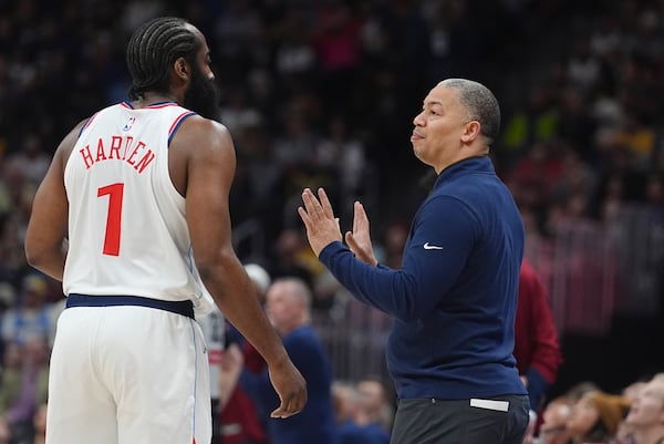 Los Angeles Clippers guard James Harden, left, confers with head coach Tyronn Lue in the first half of an NBA basketball game against the Denver Nuggets, Wednesday, Jan. 8, 2025, in Denver. (AP Photo/David Zalubowski)