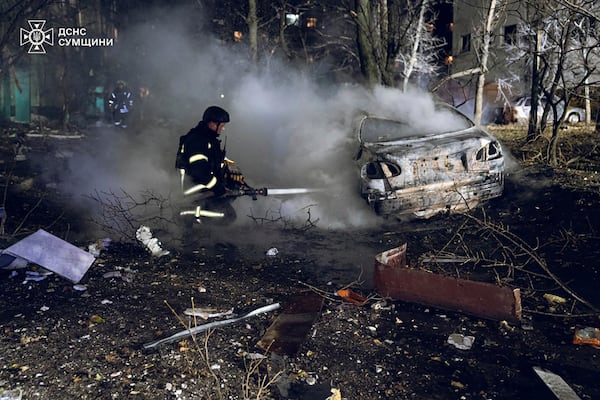 In this photo provided by the Ukrainian Emergency Service, firefighters extinguish the fire following a Russian rocket attack that hit a multi-storey apartment building in Sumy, Ukraine, Sunday, Nov. 17, 2024. (Ukrainian Emergency Service via AP)