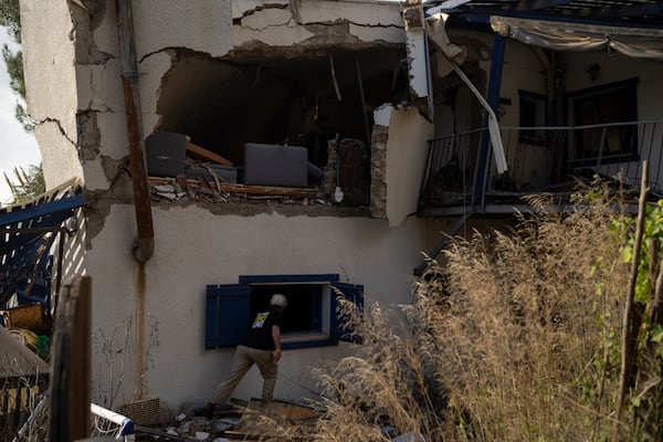 Orna Zilberstine checks a damaged house of a family friend, that was hit by a rocket fired from Lebanon, in the Kibbutz Manara, northern Israel, Thursday, Nov. 28, 2024. (AP Photo/Leo Correa)