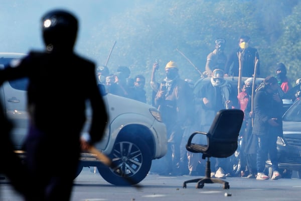 Supporters of imprisoned former Premier Imran Khan's Pakistan Tehreek-e-Insaf party throw stones toward police during clashes in Islamabad, Pakistan, Tuesday, Nov. 26, 2024. (AP Photo/Anjum Naveed)