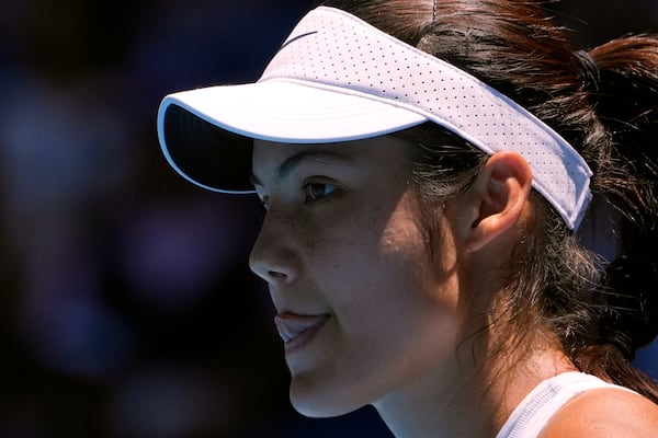 Emma Raducanu of Britain reacts during her third round match against Iga Swiatek of Poland at the Australian Open tennis championship in Melbourne, Australia, Saturday, Jan. 18, 2025. (AP Photo/Asanka Brendon Ratnayake)