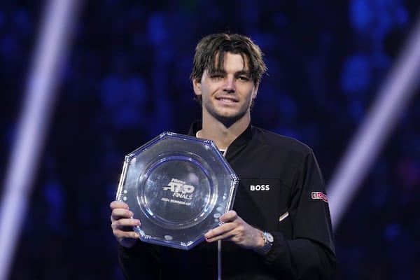 Taylor Fritz of the United States holds a second-place trophy after losing the final match of the ATP World Tour Finals against Italy's Jannik Sinner at the Inalpi Arena, in Turin, Italy, Sunday, Nov. 17, 2024. (AP Photo/Antonio Calanni)