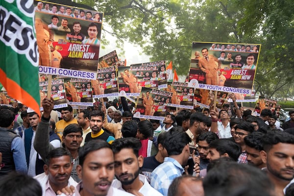 India's opposition Congress party members shout slogans during a protest against Indian billionaire Gautam Adani and Indian Prime Minister Narendra Modi after Adani was indicted by U.S. prosecutors for bribery and fraud, in New Delhi, India, Monday, Nov. 25, 2024. (AP Photo/Manish Swarup)