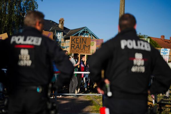 Police officers guard a protest against the far-right German party 'Alternative for Germany', near the election party location of the AfD, for the state election in the German state of Brandenburg in Potsdam, Germany, Sunday, Sept. 22, 2024. (AP Photo/Markus Schreiber)