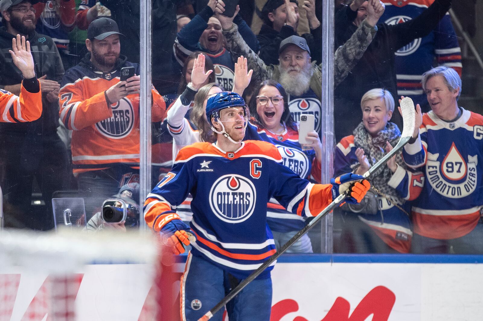 Edmonton Oilers' Connor McDavid (97) celebrates his 1000th point, against the Nashville Predators during the second period of an NHL hockey game, Thursday, Nov. 14, 2024 in Edmonton, Alberta. (Jason Franson/The Canadian Press via AP)