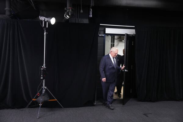 Ontario Premier Doug Ford arrives to speak to the media in the Queen's Park Legislature in Toronto on Thursday Dec. 12, 2024. (Chris Young/The Canadian Press via AP)