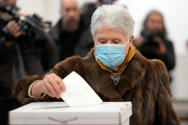 A woman casts her vote during a runoff vote for the Croatian presidential election at a polling station in Zagreb, Croatia, Sunday, Jan. 12, 2025. (AP Photo/Darko Bandic)