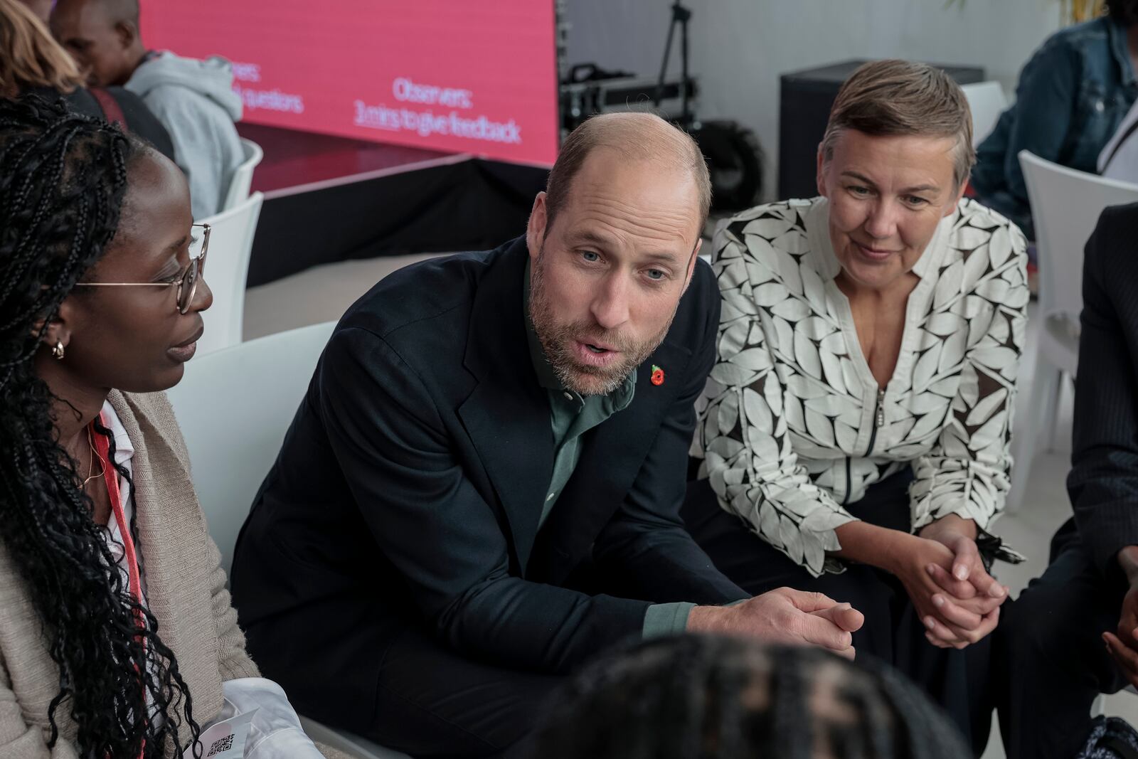 Britain's Prince William, center, and Hannah Jones, right, CEO of The Earthshot Prize, speak to a group of young people at the Earthshot Prize Climate Leaders Youth Programme at Rooftop on Bree in Cape Town, South Africa, Monday Nov. 4, 2024. (Gianluigi Guercia/Pool Photo via AP)