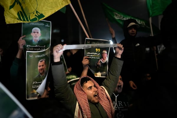 Palestinians react as they wait for the arrival of the released Palestinian prisoners, in the West Bank city of Beitunia, on Sunday, Jan. 19, 2025. (AP Photo/Leo Correa)