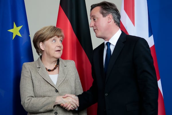 FILE - German Chancellor Angela Merkel, left, and British Prime Minister David Cameron shake hands after a news conference following a meeting at the chancellery in Berlin, Germany, Friday, May 29, 2015. (AP Photo/Markus Schreiber, File)