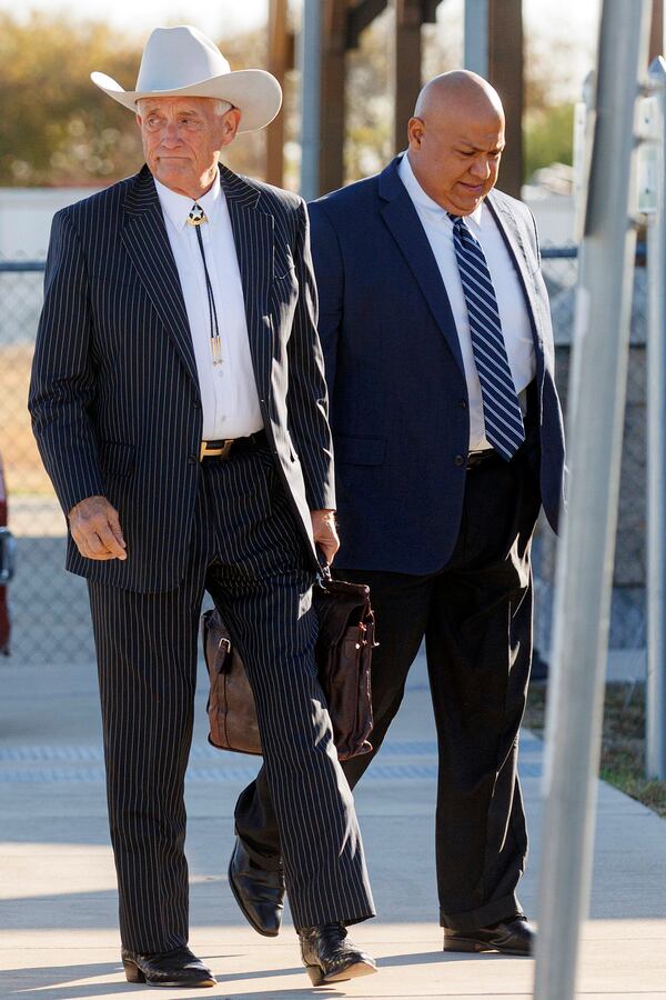 Former Uvalde school district police chief Pete Arredondo, right, and his attorney Paul Looney walk into the Uvalde County Justice Center, Thursday morning, Dec. 19, 2024, in Uvalde, Texas. (Sam Owens/The San Antonio Express-News via AP)