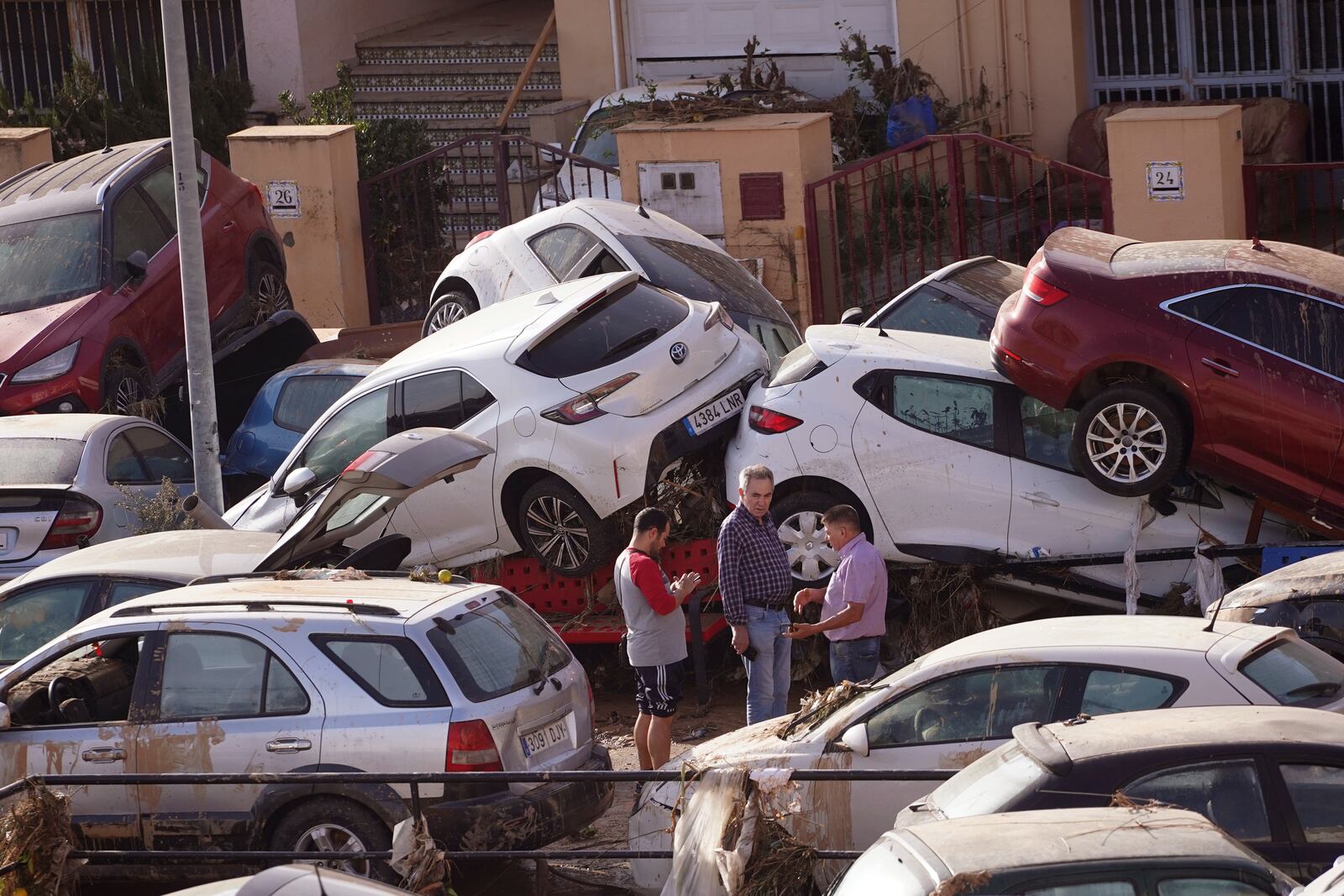 Vehicles are seen piled up after being swept away by floods in Valencia, Spain, Thursday, Oct. 31, 2024. (AP Photo/Alberto Saiz)