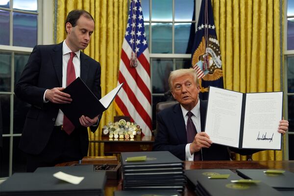 President Donald Trump signs executive orders in the Oval Office of the White House, Monday, Jan. 20, 2025, in Washington. (AP Photo/Evan Vucci)