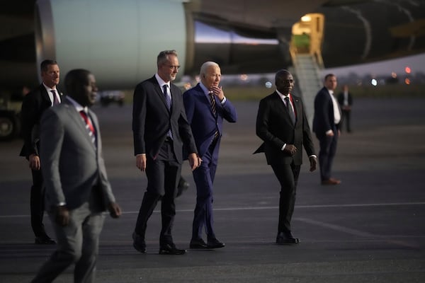 President Joe Biden is greeted by Angolan Foreign Minister Tete Antonio as he arrives at Quatro de Fevereiro international airport in the capital Luanda, Angola on Monday, Dec. 2, 2024, on his long-promised visit to Africa. (AP Photo/Ben Curtis)