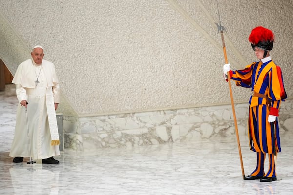 Pope Francis arrives to exchange season greetings with Vatican employees, in the Paul VI Hall at the Vatican, Saturday, Dec. 21, 2024. (AP Photo/Andrew Medichini)