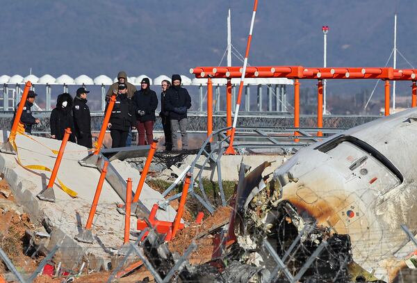 FILE - Experts from the U.S. National Transportation Safety Board (NTSB) and joint investigation team between the U.S. and South Korea check the site of a plane crash at Muan International Airport in Muan, South Korea, Dec. 31, 2024. (Son Hyung-joo/Yonhap via AP, File)