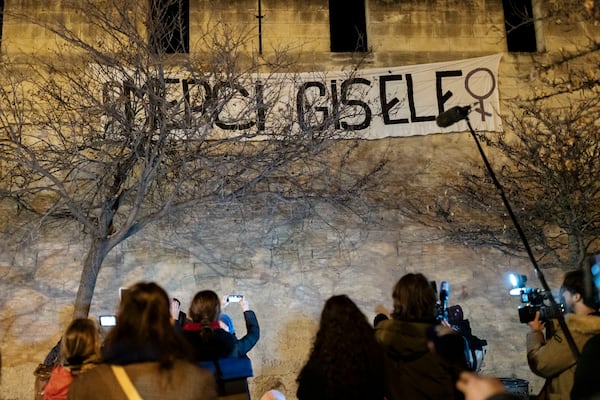 Feminist collective "Les Amazones Avignon" hang a banner reading "Thank you Gisele" around the courthouse where the Mazan rape trial is taking place in Avignon, Wednesday, Dec. 18, 2024. (AP Photo/Lewis Joly)