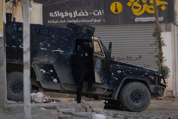 Armored Palestinian security vehicles are seen on the road as Palestinian forces mount a major raid against militants in the Jenin refugee camp in the Israeli-occupied West Bank, Monday, Dec. 23, 2024. (AP Photo/Majdi Mohammed)