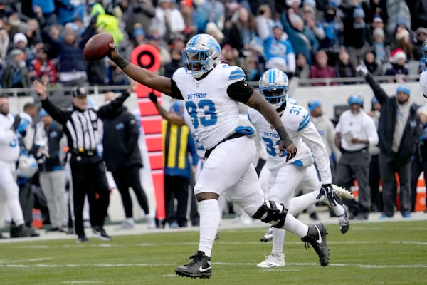 Detroit Lions defensive end Josh Paschal celebrate his recovery of a Chicago Bears fumble during the first half of an NFL football game Sunday, Dec. 22, 2024, in Chicago. (AP Photo/Nam Y. Huh)