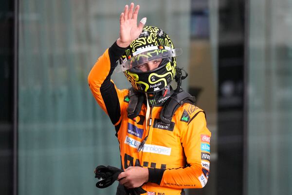 McLaren driver Lando Norris of Britain waves after winning the pole position during sprint qualifying at the Lusail International Circuit in Lusail, Qatar, ahead of the Qatar Formula One Grand Prix, Friday, Nov. 29, 2024. (AP Photo/Darko Bandic, Pool)