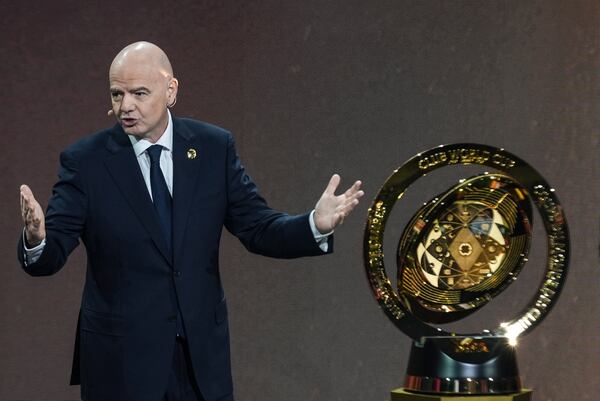 FILE - FIFA President Gianni Infantino' speaks next to the trophy during the draw for the 2025 FIFA Club World Cup soccer tournament, Thursday, Dec. 5, 2024, in Miami. (AP Photo/Rebecca Blackwell, File)