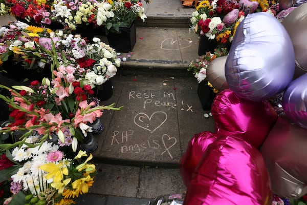 FILE - Tributes are seen outside the Town Hall in Southport, England, Aug. 5, 2024 after three young girls were killed in a knife attack at a Taylor Swift-themed holiday club the week before. (AP Photo/Darren Staples, File)